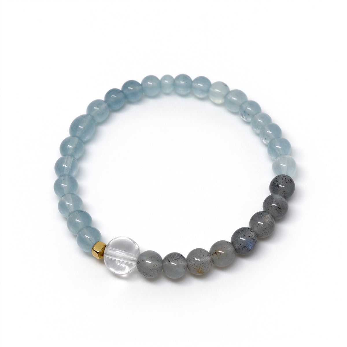 Angled view of aquamarine and moonstone bracelet featuring 18K gold-plated spacer
