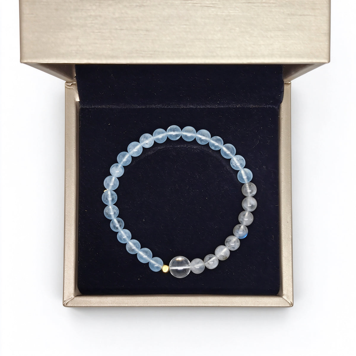 Natural aquamarine and moonstone bracelet resting flat in black velvet box