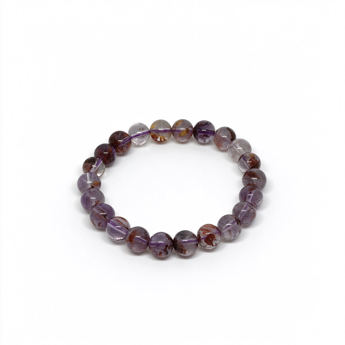 Angled view of genuine purple phantom quartz beaded bracelet showing internal inclusions