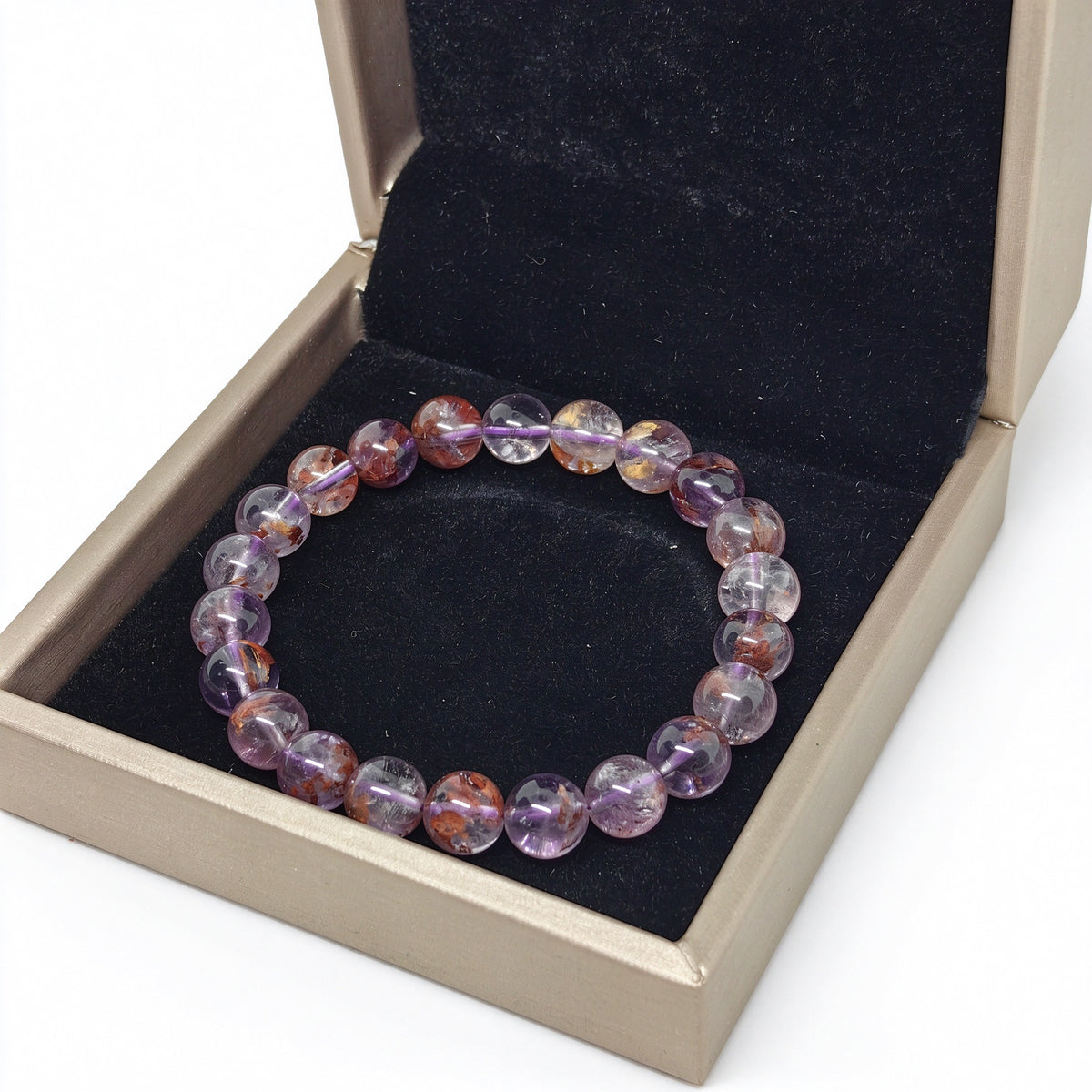 Angled view of purple phantom quartz bracelet in open luxury jewelry presentation box