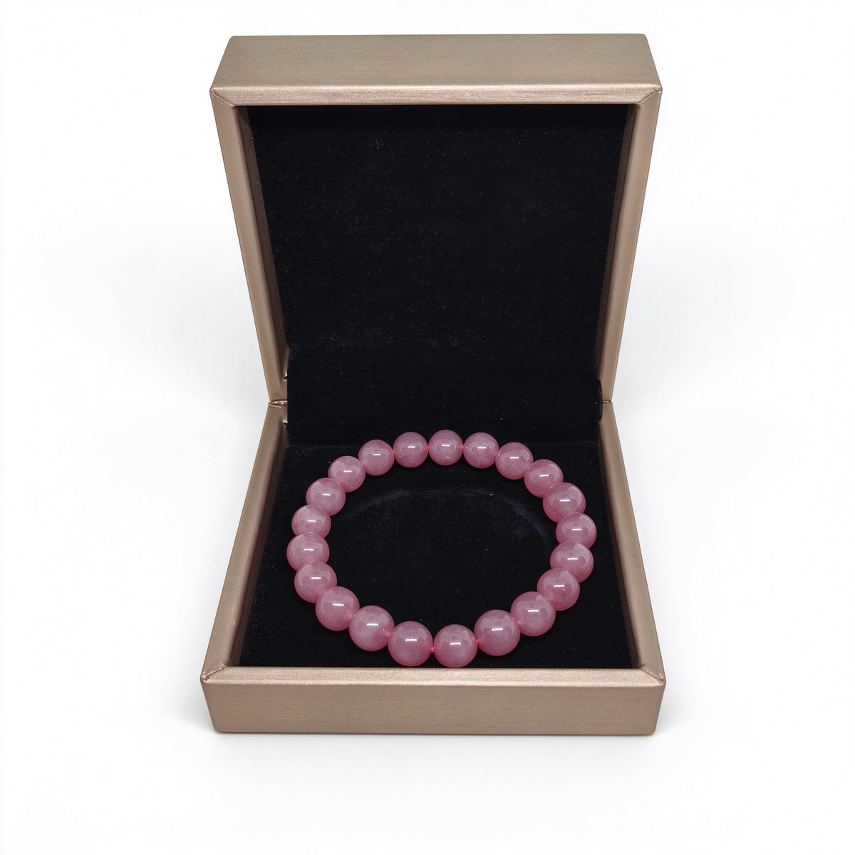 Front angle view of natural rose quartz bracelet inside open presentation box