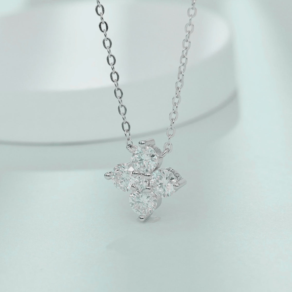 Video showcasing the fire and sparkling movement of four-leaf clover moissanite necklace