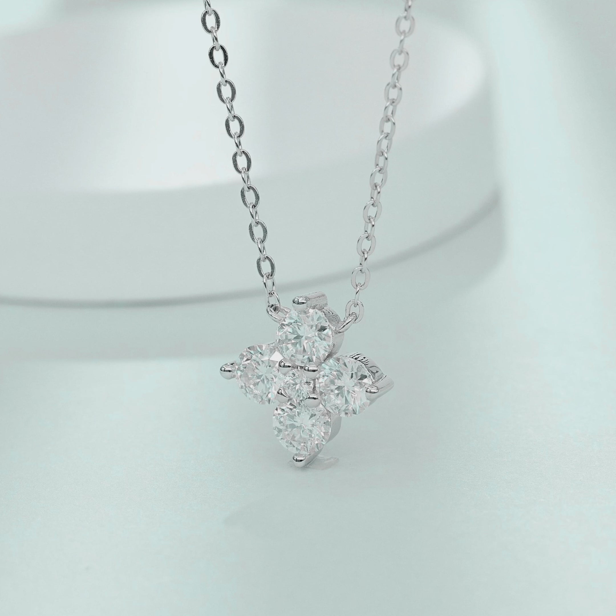 Video showcasing the fire and sparkling movement of four-leaf clover moissanite necklace