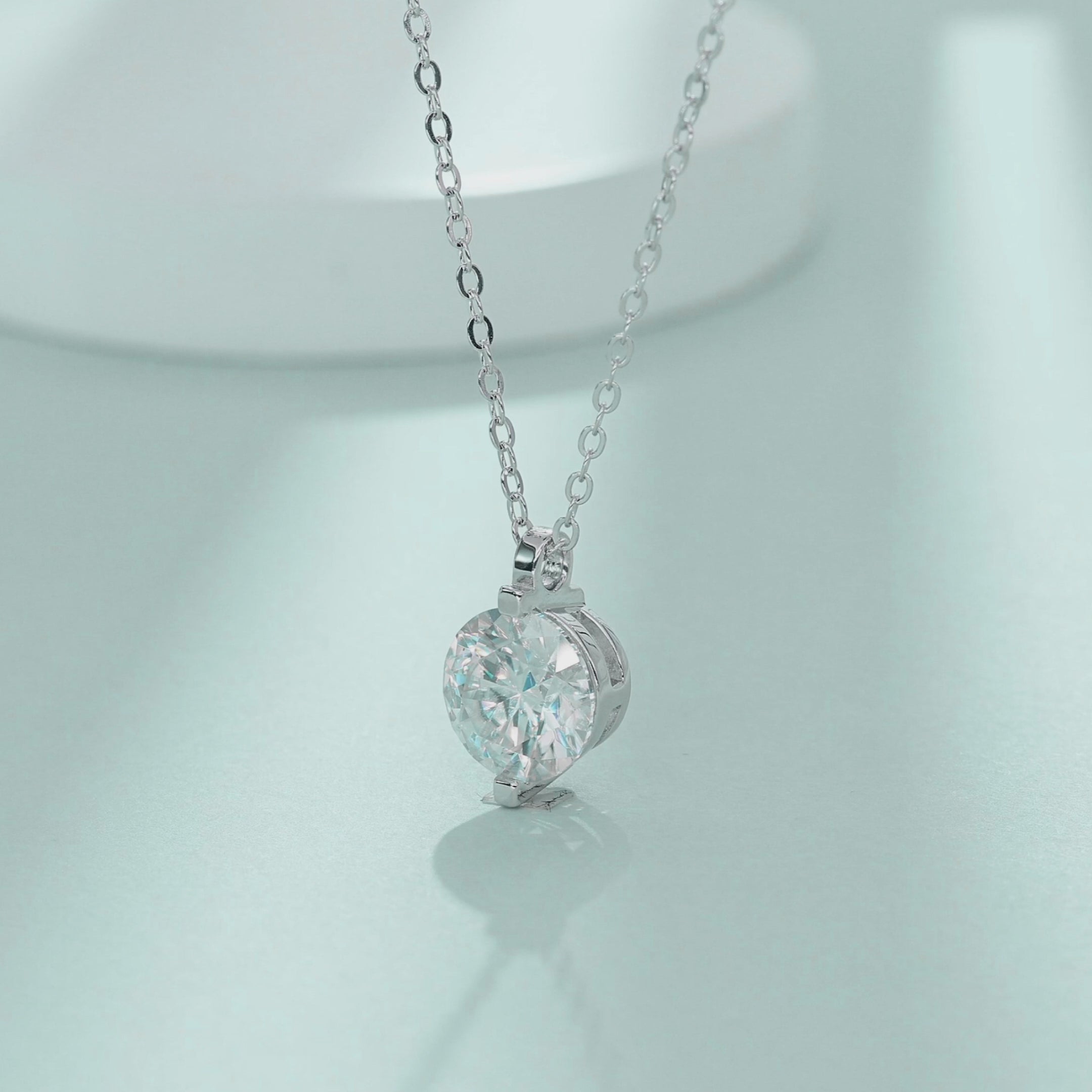 Video highlighting brilliance and open-side light exposure of 1.0ct moissanite 2-prong necklace
