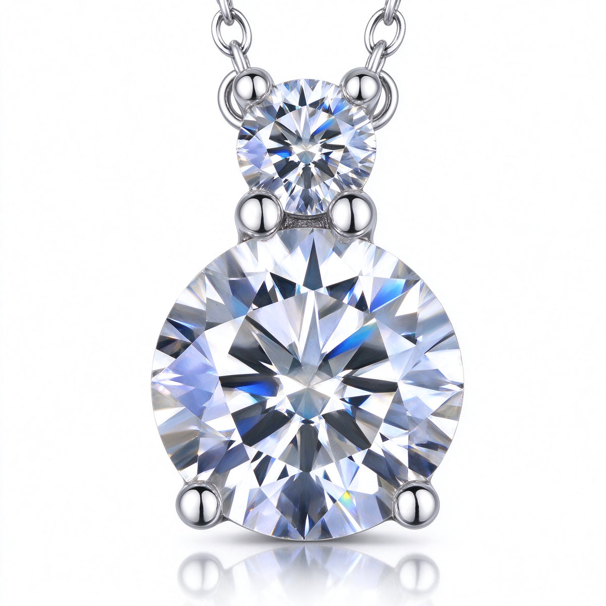 Macro close-up of 1.1ct total weight tiered round moissanite drop stones and prongs