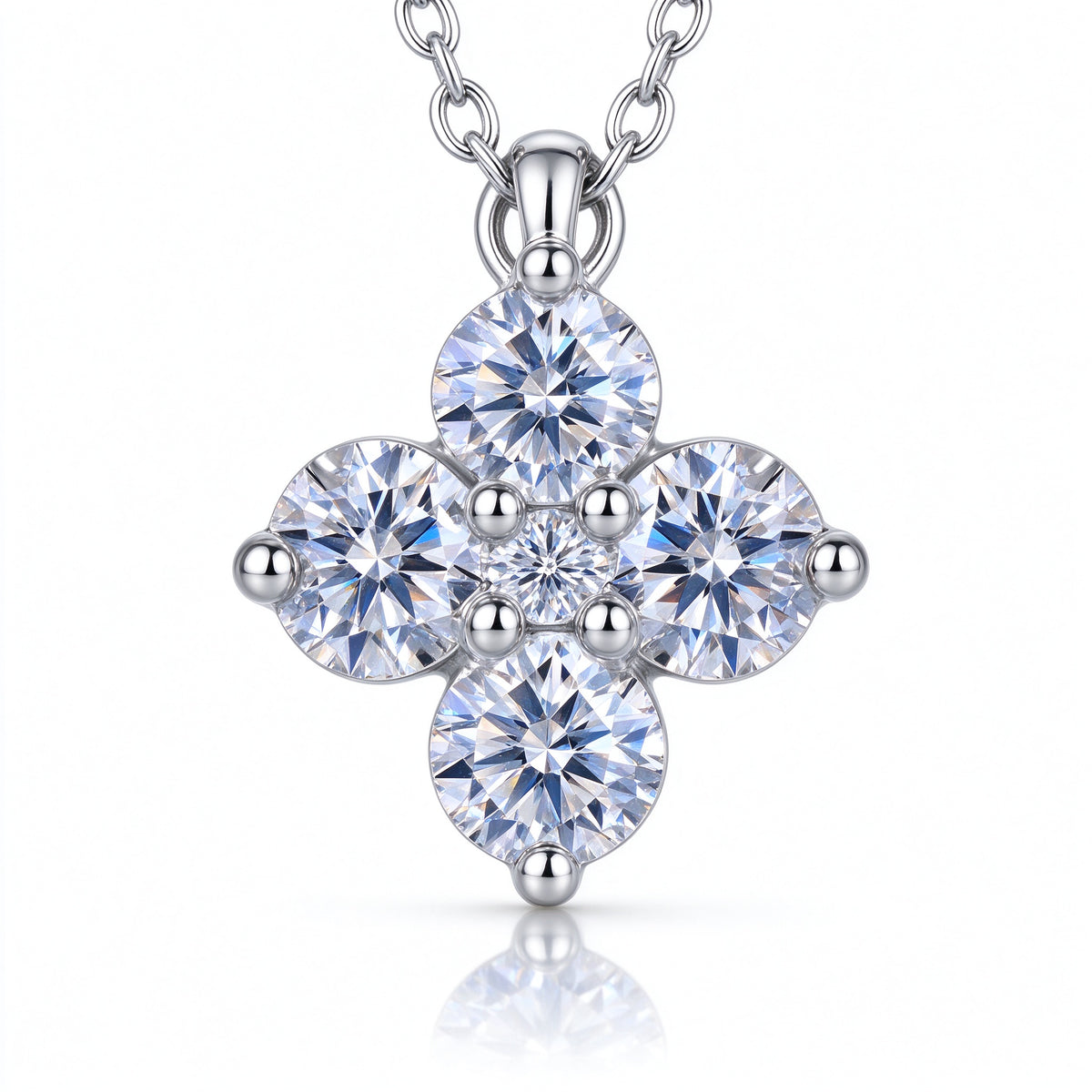 Macro close-up of four-leaf clover pendant showing brilliant 5-stone moissanite cluster