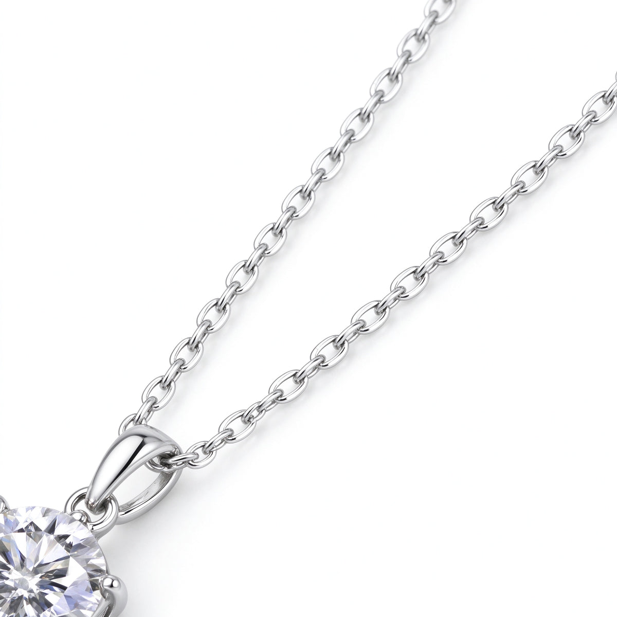 Detail of 925 sterling silver chain connected to polished teardrop pendant bail
