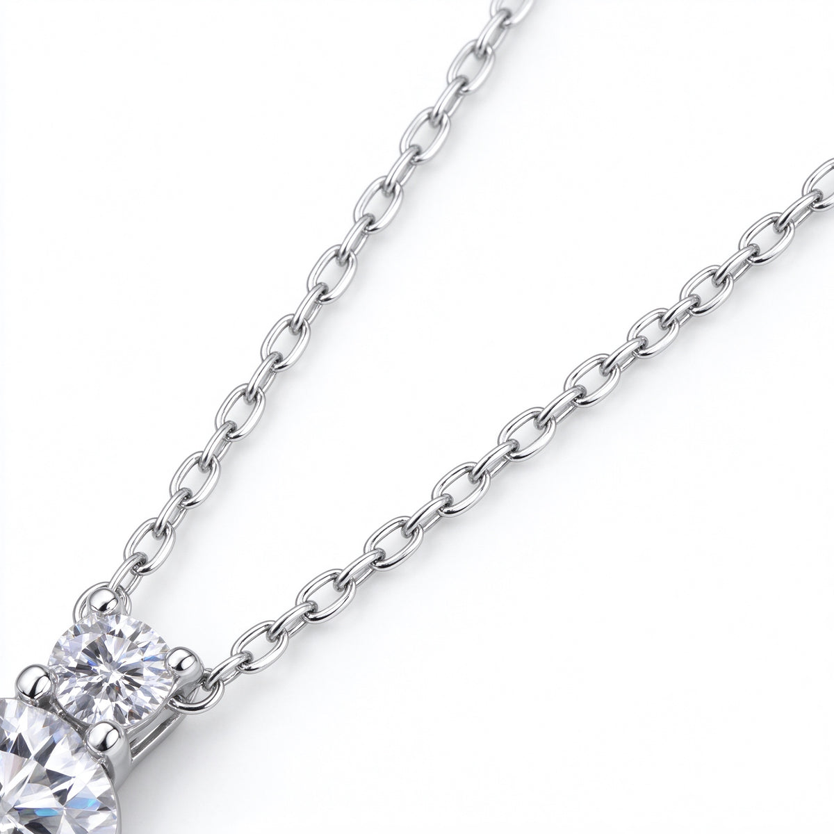 Detail of 925 sterling silver cable chain connected to two-stone moissanite pendant