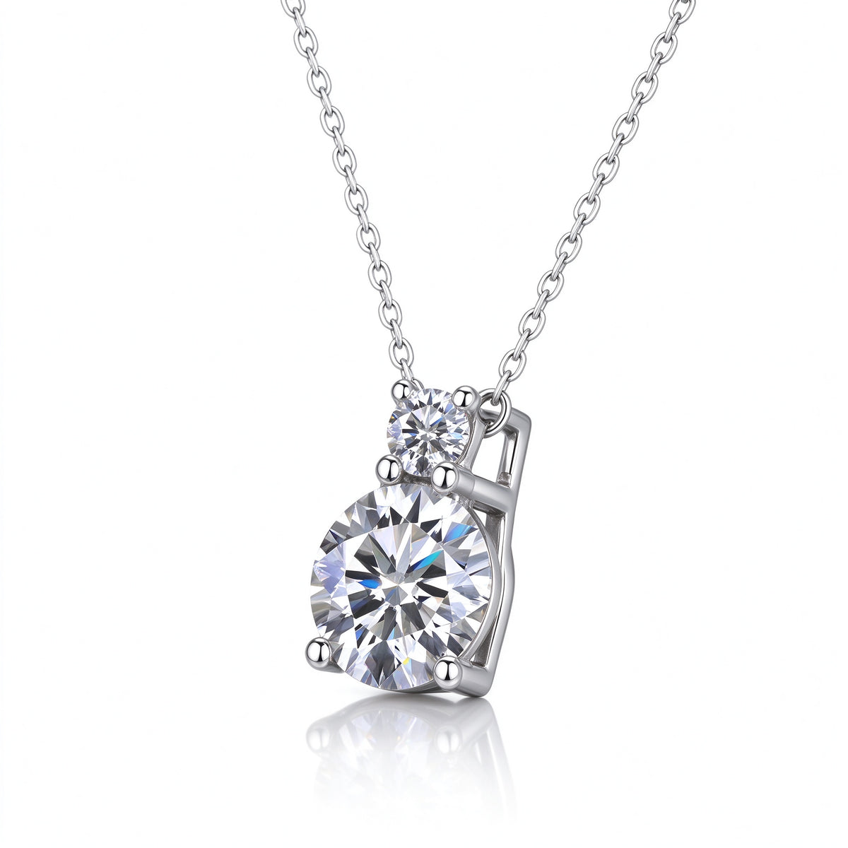 Angled perspective view of tiered two-stone moissanite pendant on reflective surface